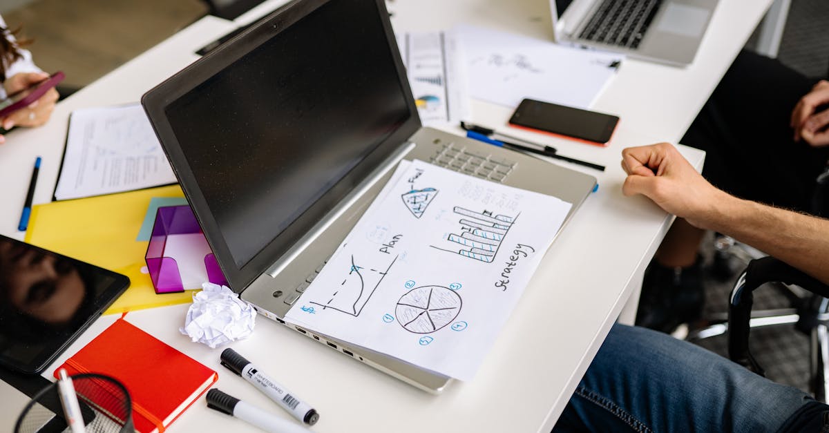 Company paperwork and a laptop for a solo operator's business administration.