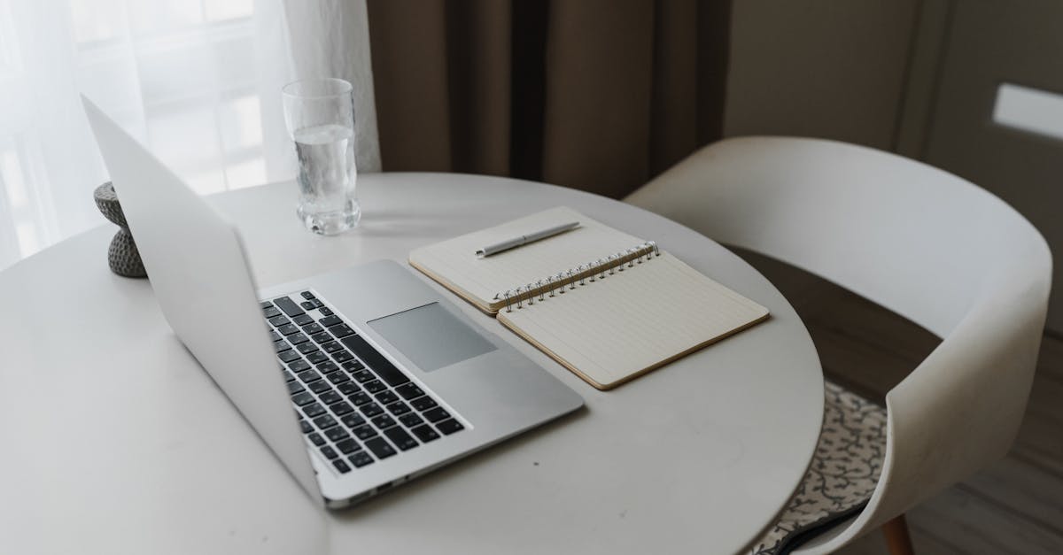 A laptop, notebook, and travel workspace for a solo web business operating model.